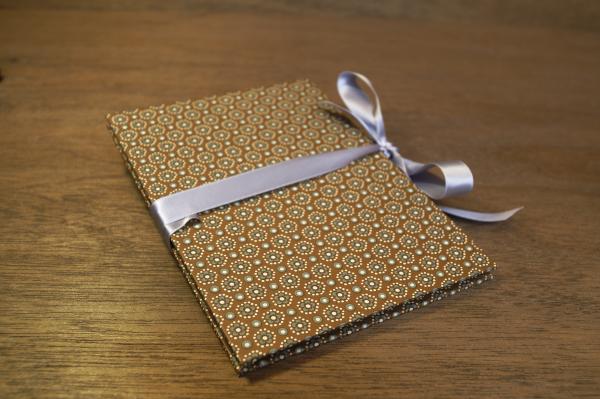 Cappuchino colored leporello with graphic flowers and light gray bow